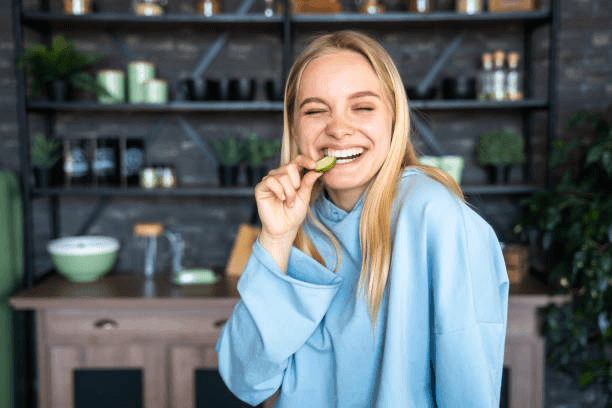 a girl eating cucumber