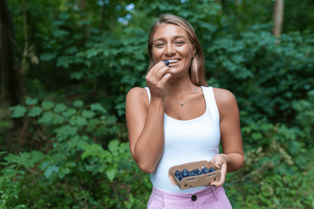 image of a person eating blueberries